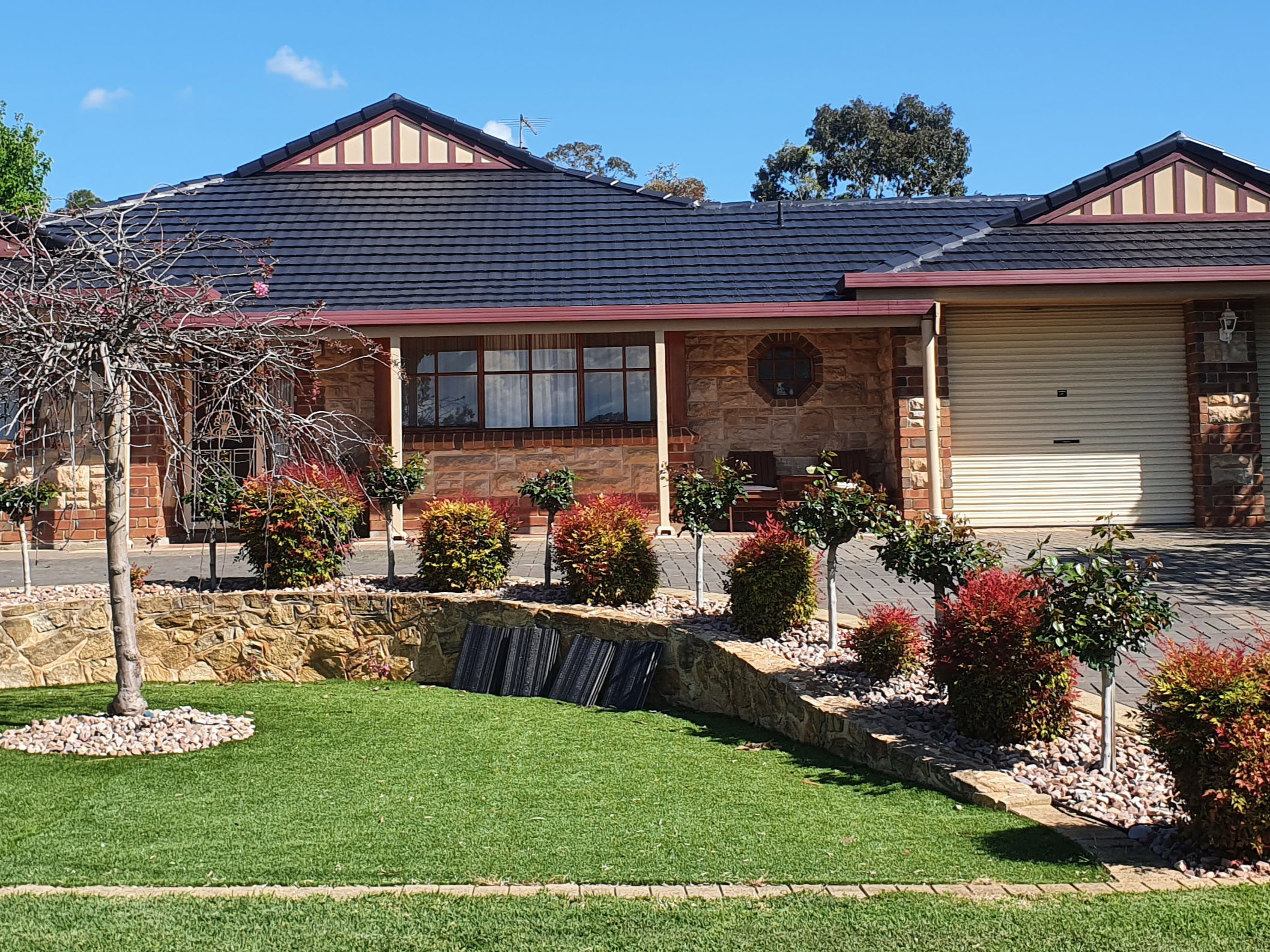 Restored dark tiled roof and guttering